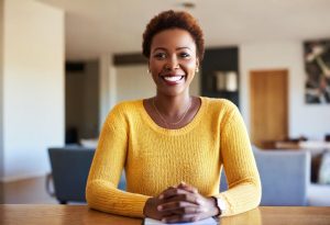 a black woman smiles as she begins financial planning for retirement